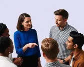 Group of six diverse people standing in a circle talking and smiling against a plain background.